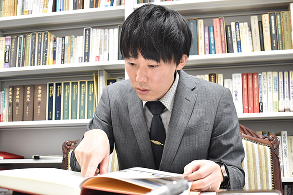 （『名古屋市立大学70年史』を読みながら当時を振り返る手嶋さん）